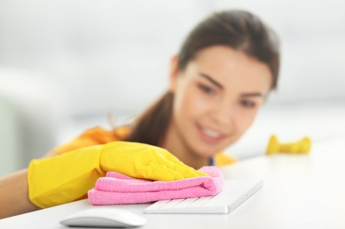 Cleaner applying safe working practices during a carpet clean