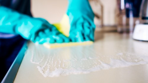 Deep cleaning equipment used on a modern sofa