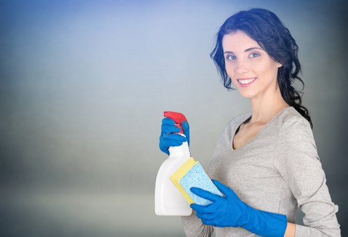 Technician performing upholstery cleaning on a modern armchair